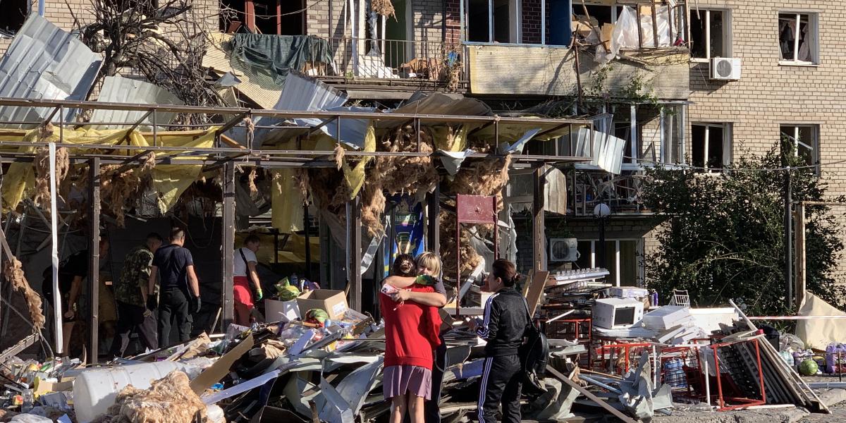 Lakosok egy megrongálódott lakóépület mellett 2025. augusztus 30-án Zaporizzsjában