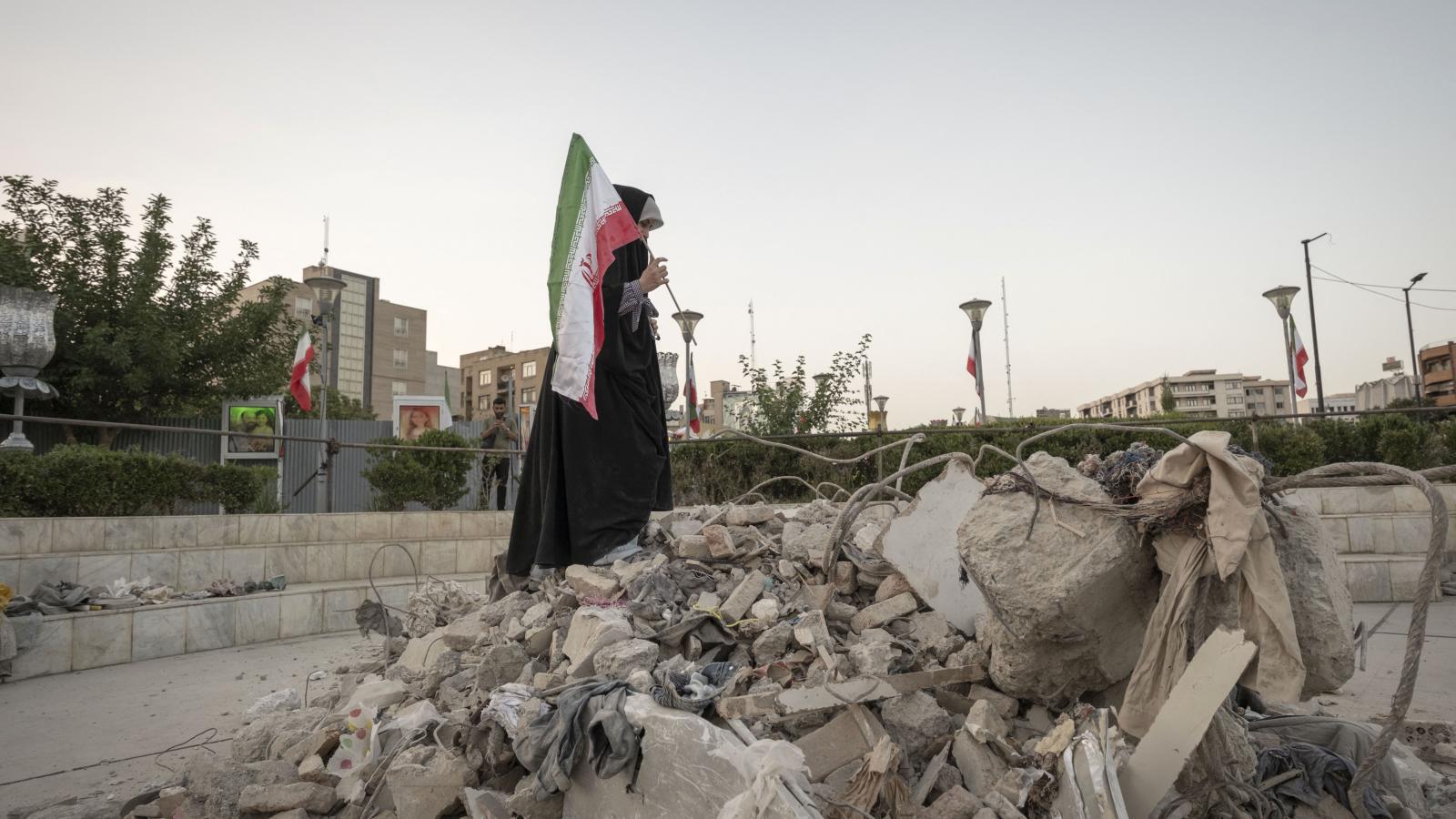 Képünk illusztráció, iráni diáklány egy épület romjai mellett Teheránban 2025. június 21-én