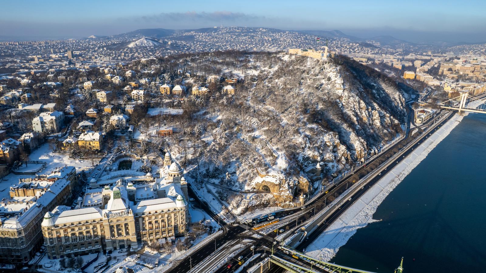 A Gellért-hegy, előtérben a Szent Gellért tér és a Gellért Szálló a behavazott Budapesten 2026. január 8-án