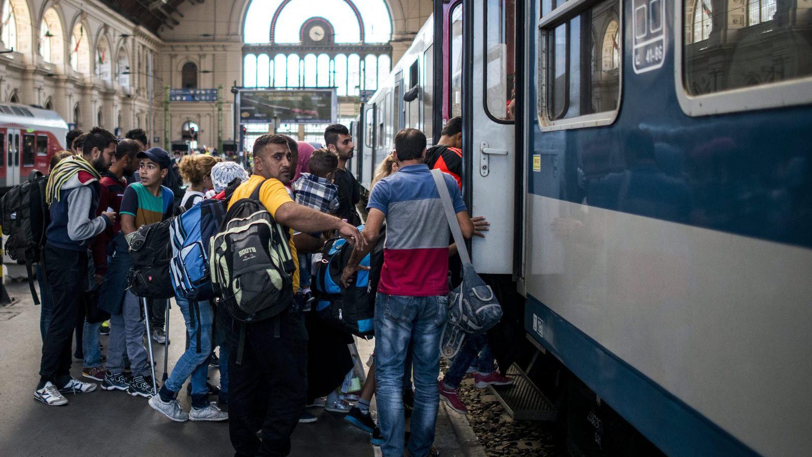 Migránsok felszállnak egy Bécsbe tartó vonatra a Keleti pályaudvaron 2015. szeptember 9-én. MTI Fotó: Marjai János