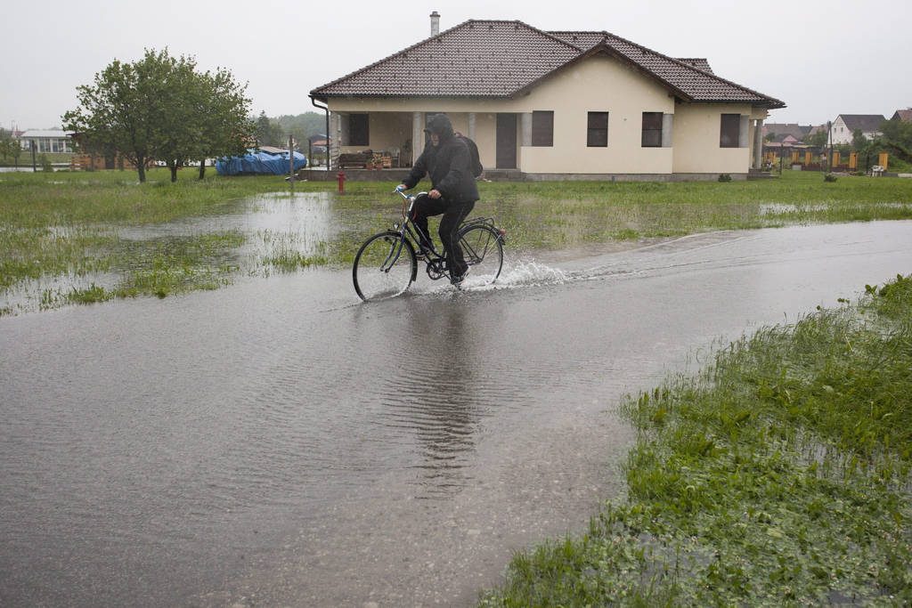 Egy férfi kerékpározik a vízben a Somogy megyei Barcs egyik utcájában 2014. május 4-én. Fotó: Varga György/MTI